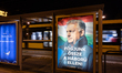 An illuminated campaign poster featuring Hungarian Prime Minister Viktor Orban is displaye...