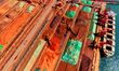 A cargo ship unloads imported iron ore at the Qingdao Port Ore Terminal in Shandong, China...