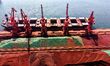 A cargo ship unloads imported iron ore at the Qingdao Port Ore Terminal in Shandong, China...