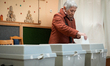 A woman places her ballot at a voting station in Budapest, Hungary on 12 April, 2026. 