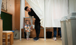 A man looks while exiting a voting booth in Budapest, Hungary on 12 April, 2026. 