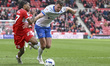 Sontje Hansen of Middlesbrough drives forward and goes down under pressure from Conor Shau...