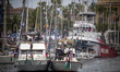Dozens of vessels depart from the port of Barcelona as part of an international flotilla b...