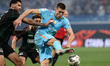 Aleksandr Sobolev (C) of Zenit and Vitor Tormena (L) of Krasnodar vie for the ball during...