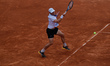 James Duckworth of Australia lunges to play a forehand against Stefano Napolitano of Italy...