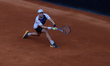 James Duckworth of Australia lunges to play a forehand against Stefano Napolitano of Italy...