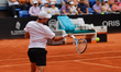 James Duckworth of Australia lunges to play a forehand against Stefano Napolitano of Italy...