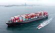 A cargo ship loaded with foreign trade containers sails towards Qingdao Port along Jiaozho...
