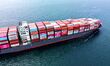 A cargo ship loaded with foreign trade containers sails towards Qingdao Port along Jiaozho...
