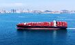 A cargo ship loaded with foreign trade containers sails towards Qingdao Port along Jiaozho...