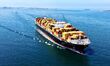 A cargo ship loaded with foreign trade containers sails towards the open sea in Jiaozhou B...
