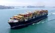 A cargo ship loaded with foreign trade containers sails towards the open sea in Jiaozhou B...