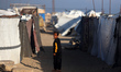 A displaced Palestinian looks outside a tent inside Gaza City's port on April 13, 2026. Bo...