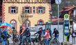 Cyclists gather with bicycles near Tegernsee train station and bus stop in Tegernsee, Bava...