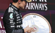 George Russell of the Mercedes AMG F1 Team celebrates on the podium ahead of the Australia...