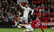 Jayden Bogle of Leeds United is tackled by Luke Shaw of Manchester United during the Premi...