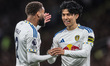 Ao Tanaka of Leeds United speaks to Jayden Bogle of Leeds United during the Premier League...