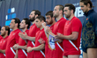 Players from the Georgia water polo national team applaud after the playing of their count...