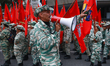 Militia members and military personnel participate in a march to commemorate National Civi...
