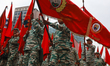 Militia members and military personnel participate in a march to commemorate National Civi...
