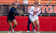 Payton Tini of the Rutgers Scarlet Knights holds the ball while Katharine Merrifield of th...
