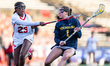 Ceci Stein of the Michigan Wolverines possesses the ball while Charlee Thomas of the Rutge...