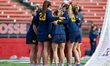 The Michigan Wolverines huddle during an NCAA women's lacrosse game at SHI Stadium in Pisc...