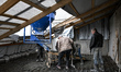 Builders work at a nine-storey apartment block on Motorobudivnykiv Avenue in Zaporizhzhia,...