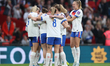 Lauren Hemp of England is hugged by her teammates after scoring during the FIFA Women's Wo...