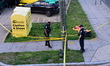 Members of the Metropolitan Police Department work at the scene where one boy is shot and...
