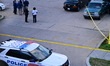 Members of the Metropolitan Police Department work at the scene where one boy is shot and...