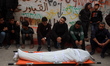 Mourners gather around the bodies of Palestinians at Al Shifa Hospital in Gaza City, on Ap...