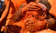 Nepali revelers apply vermillion powder on each other during Sindoor Jatra, also known as...