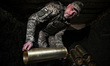 A soldier from an artillery crew of the 260th Separate Territorial Defence Brigade prepare...