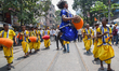 Indian folk artists perform during a roadshow alongside BJP candidates Purnima Chakraborty...