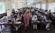 Students arrive to sit for the Primary School Scholarship Examination at Segunbagicha High...