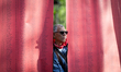 A man stands near banners displaying names of children killed in Palestine since October 2...