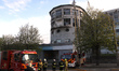 Firefighters use an aerial ladder platform to reach the roof of an academic institution da...