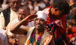 Sujan Bagh Shrestha wears white turf and greets the crowd after participating in the tongu...