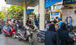Motorists queue to refuel at a fuel station in Ahmedabad, India, on April 15, 2026. Rising...