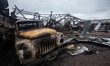 A burned-out truck and a destroyed auto repair shop are seen following a drone strike in t...