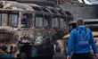 A member of the Proliska organization surveys damage at a bus depot in the city of Shostka...