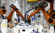 Robots produce automotive body sheet metal products in the production workshop of a mold s...