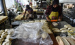 A worker prepares the dough for ''Roti Sultan'' white bread at a home industry bakery in M...