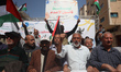 Palestinians participate in a protest at the headquarters of the International Committee o...