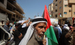 Palestinians participate in a protest at the headquarters of the International Committee o...