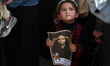Palestinians participate in a protest at the headquarters of the International Committee o...