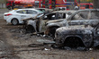 Burnt-out cars stand in a parking lot after a Russian military operation in Kyiv, Ukraine,...