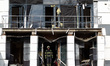 A rescuer stands in the doorway of a minihotel in the Podilskyi district damaged during a...