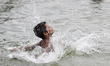 Children bathe in the water amid intense heat in Dhaka, Bangladesh, on April 16, 2026. 